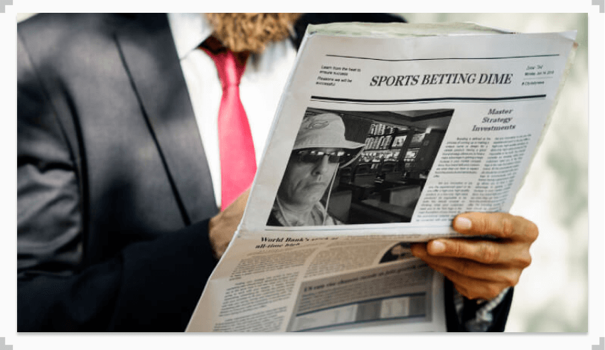 photo of a man reading the anthony best interview in a newspaper