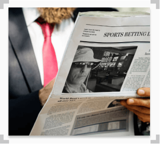 photo of a man reading the anthony best interview in a newspaper