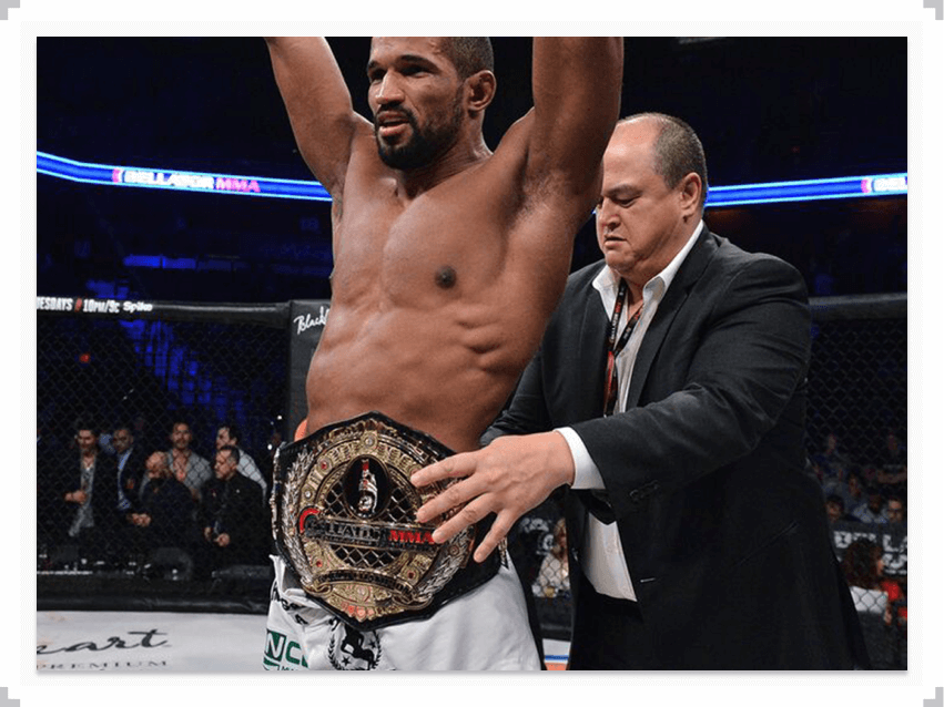 Rafael Carvalho arms raised with championship belt around his waist