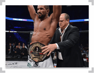 Rafael Carvalho arms raised with championship belt around his waist