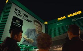 Tom Brady Vince Vaughn looking at poster side of MGM Grand building