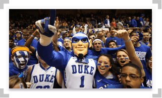 Duke mascot holding up one finger in a crowd