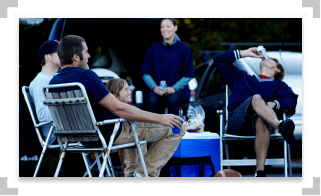 People hanging out at a tailgate party