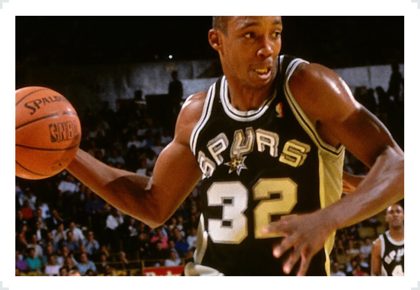 Sean Elliot San Antonio Spurs holding basketball one hand