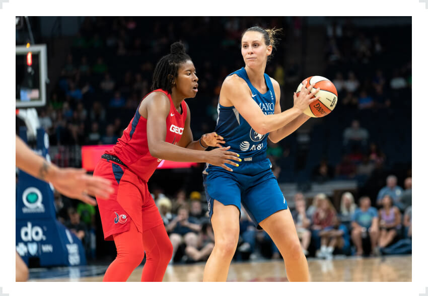 Minnesota Lynx player with ball in hands defended by opponent