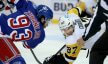Pittsburgh Penguins center Sidney Crosby takes a face off against New York Rangers center Mika Zibanejad