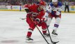 Carolina Hurricanes center Sebastian Aho skates with puck past New York Rangers defenseman Ben Harpur