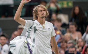 Alexander Zverev addressing the crowd with his arm.