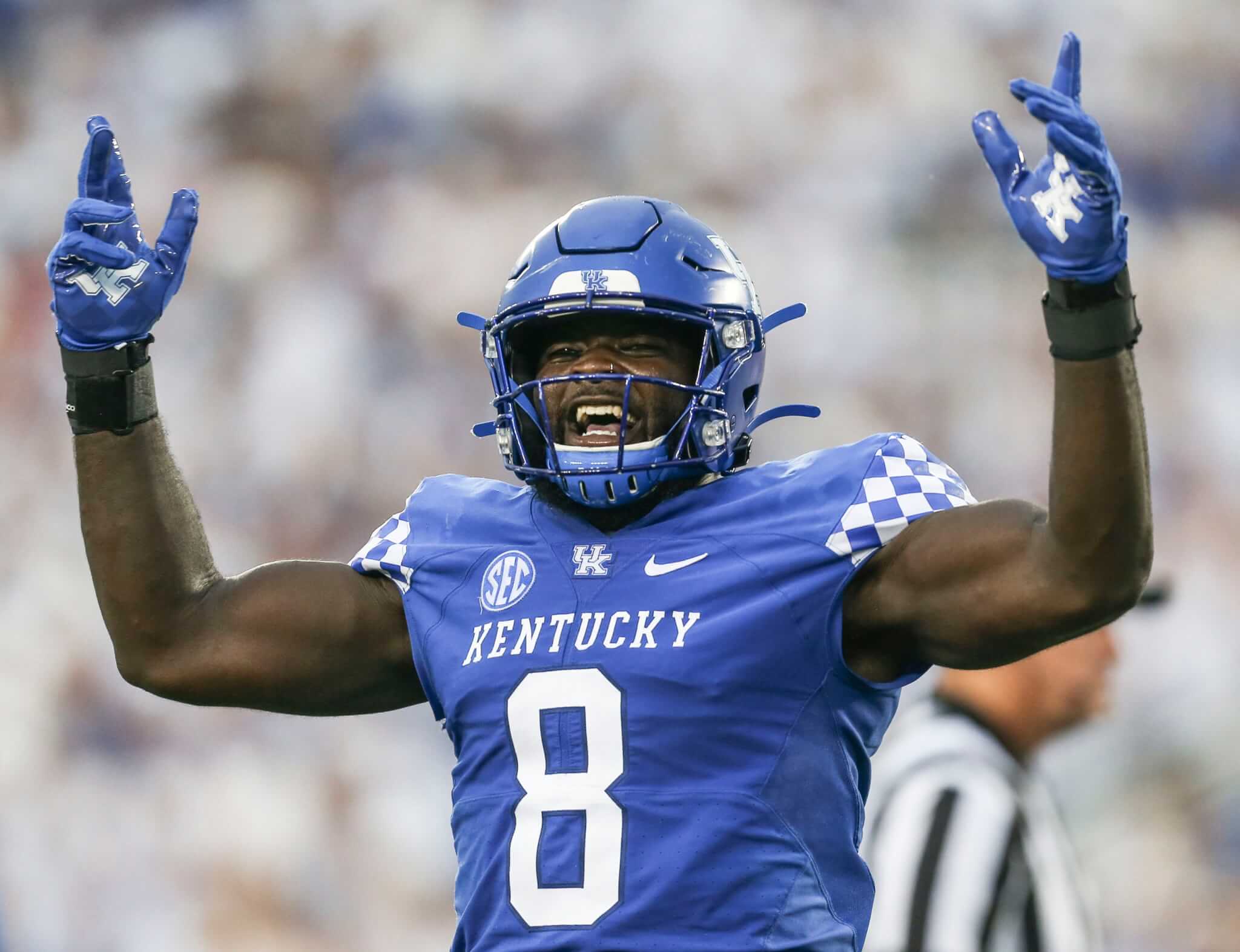 Kentucky Wildcats Football player Octavious Oxendine arms up in air