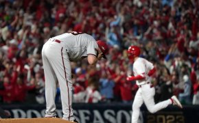 Arizona Diamondbacks pitcher Merrill Kelly holds his head in his hands after a Trea Turner home run