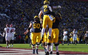 Michigan Wolverines running back Blake Corum is congratulated by offensive lineman LaDarius Henderson