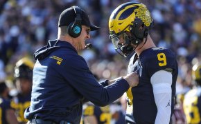 Michigan coach Jim Harbaugh talks to quarterback J.J. McCarthy