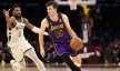 Los Angeles Lakers guard Austin Reaves drives to the basket against Milwaukee Bucks guard Malik Beasley