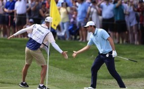 Scottie Scheffler celebrates with caddie Ted Scott at THE PLAYERS Championship in 2023