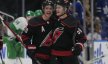 Carolina Hurricanes forward Sebastian Aho congratulates forward Jake Guentzel