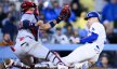 Los Angeles Dodgers first baseman Freddie Freeman slides into home as St. Louis Cardinals catcher Ivan Herrera tries to apply the tag